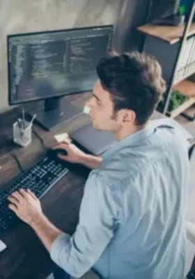 web designer analyzing code and website UI layout on a desktop screen.